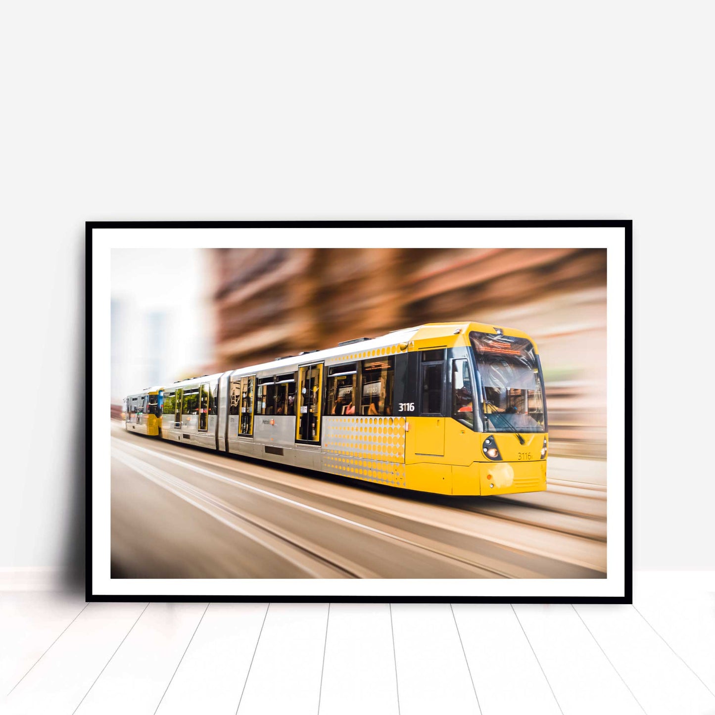 Photographic print of Manchester Tram with motion blur effect making the tram look like it is speeding, taken in Manchester, England, UK.