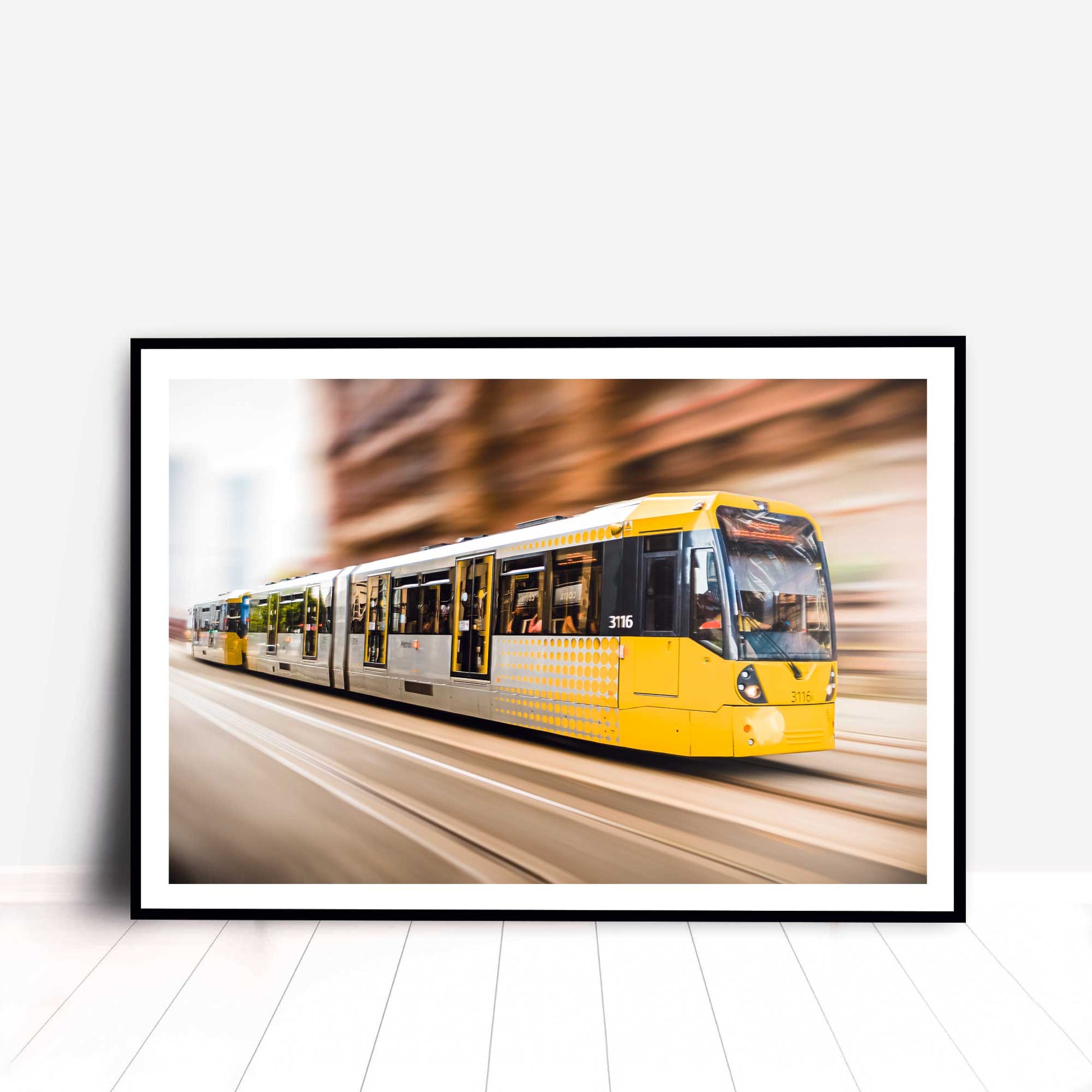 Photographic print of Manchester Tram with motion blur effect making the tram look like it is speeding, taken in Manchester, England, UK.