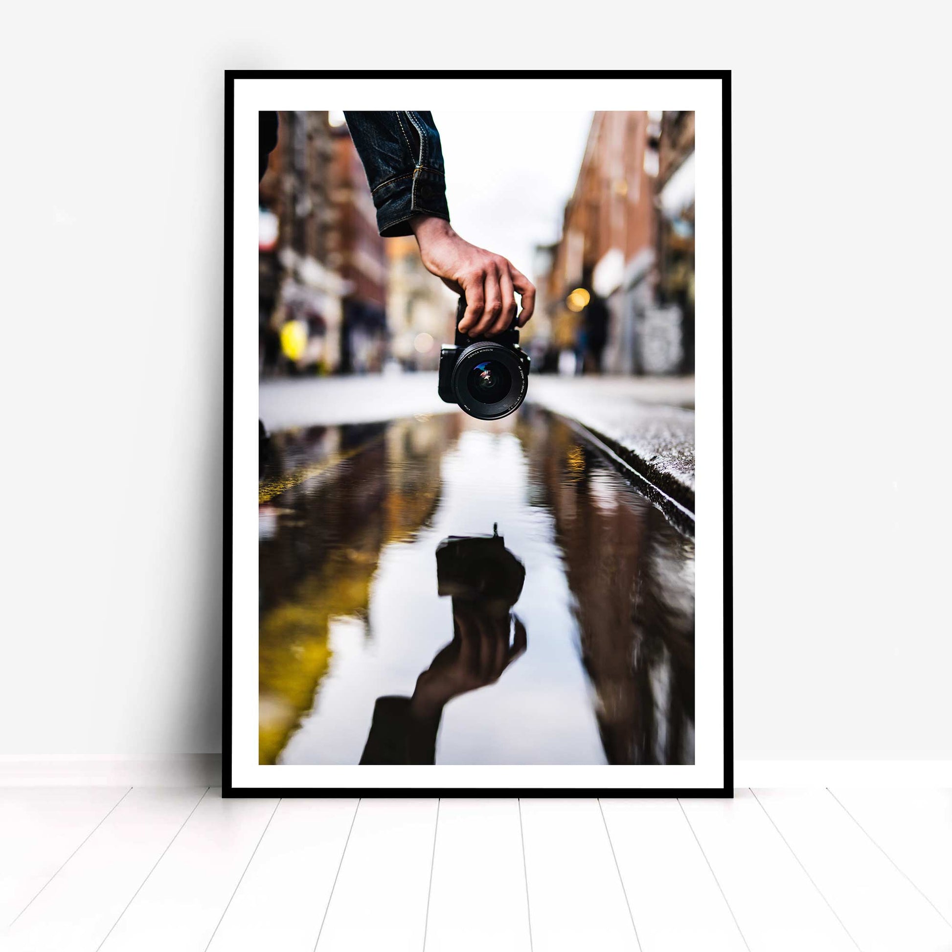 Photographic Print Showing Reflection of a Hand holding a Hand-Held Camera.