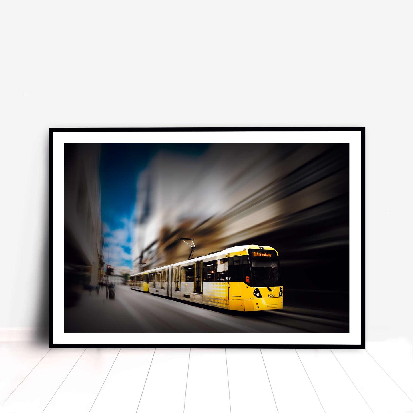 Photographic print of Manchester Tram with motion blur effect making the tram look like it is speeding, taken in Manchester, England, UK.
