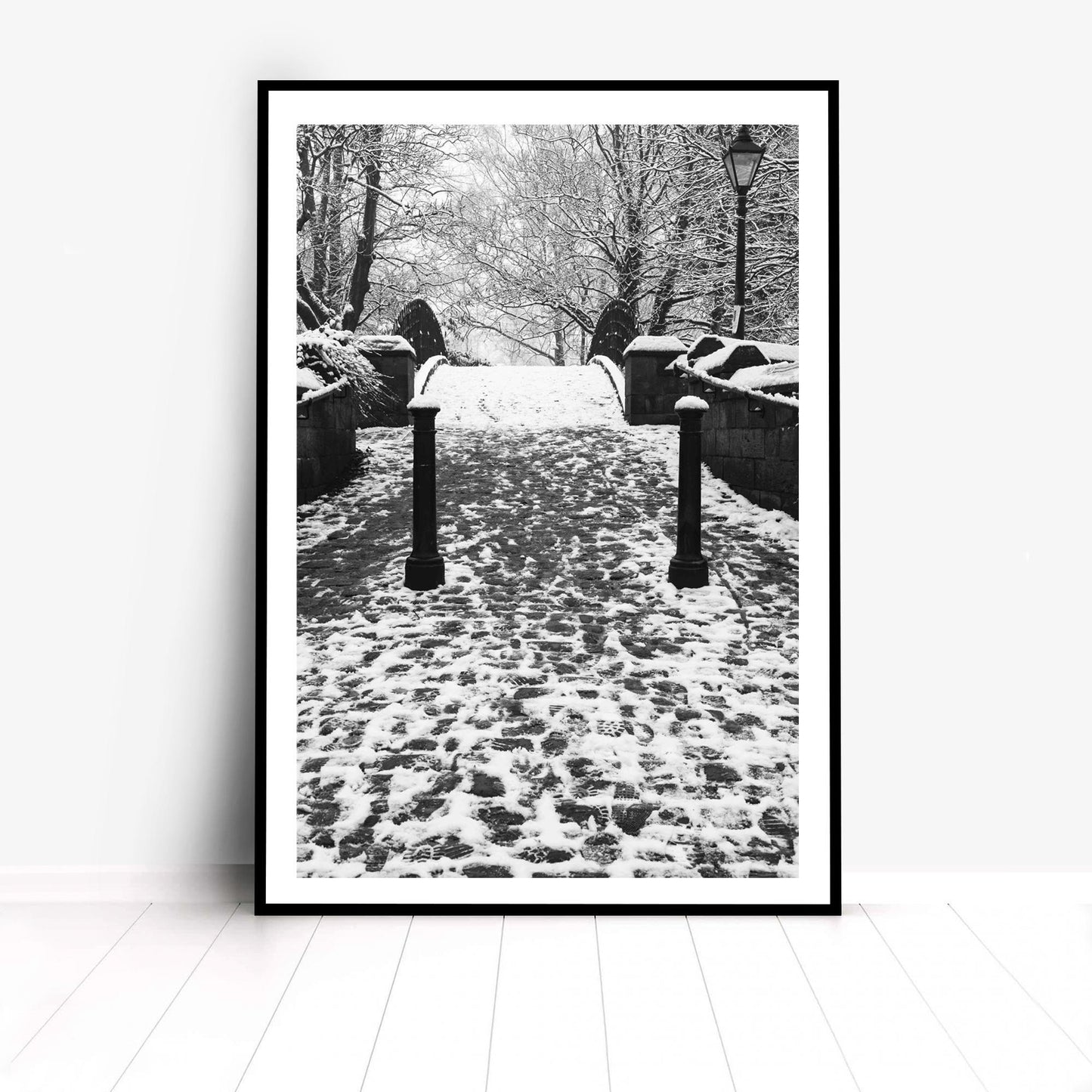 Richard Abram Photography - The photographic scenic print was taken on the Worsley canal in Greater Manchester. Taken on a wintery morning day. The image shows a snow scene with the cast-iron footbridge covered in winter snowy footprints.
