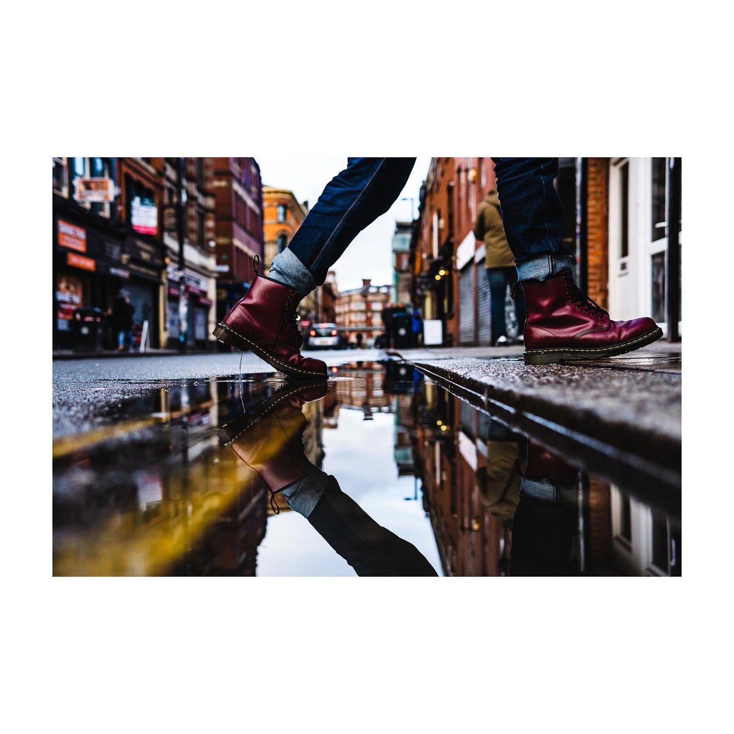 Richard Abram Photography - Street Photography Red Boots Reflection in a puddle with yellow lines leading into the distance. Digital Photography Fine Art Print A4, A3, A2