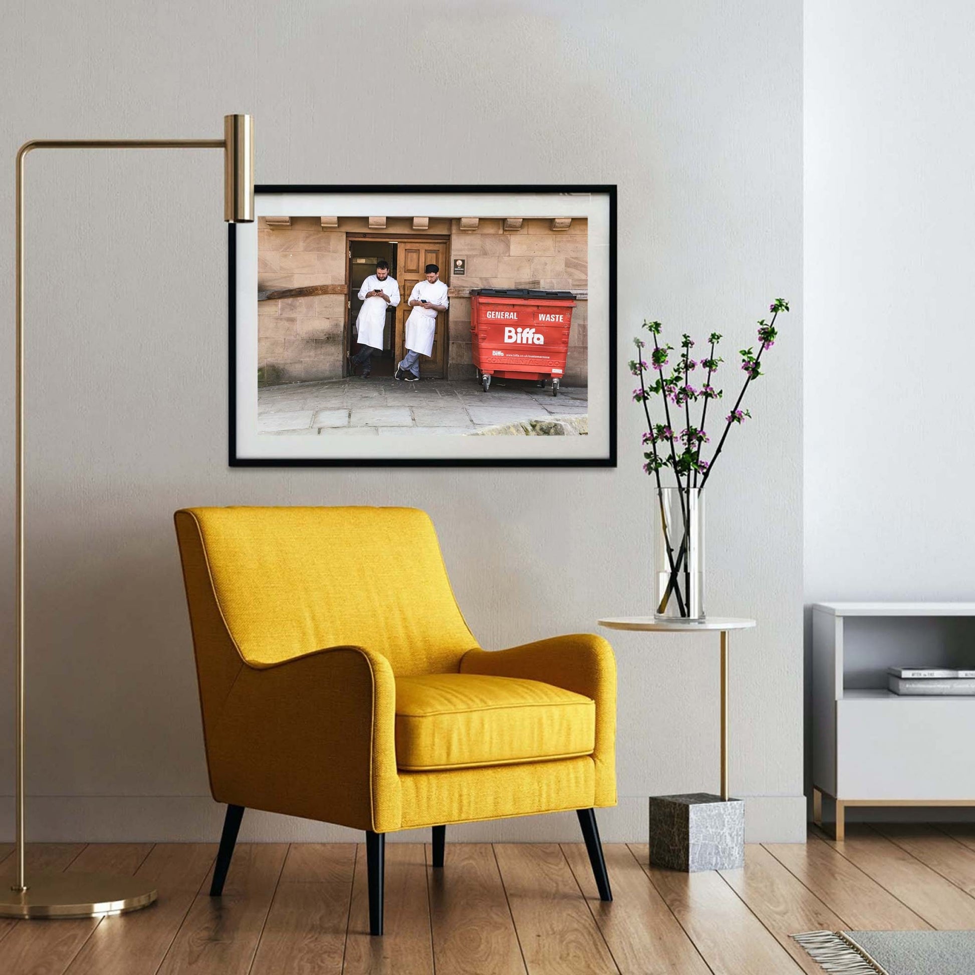 A photographic print was taken in Manchester, England showing street photography of two men on a break who stood by a wall.