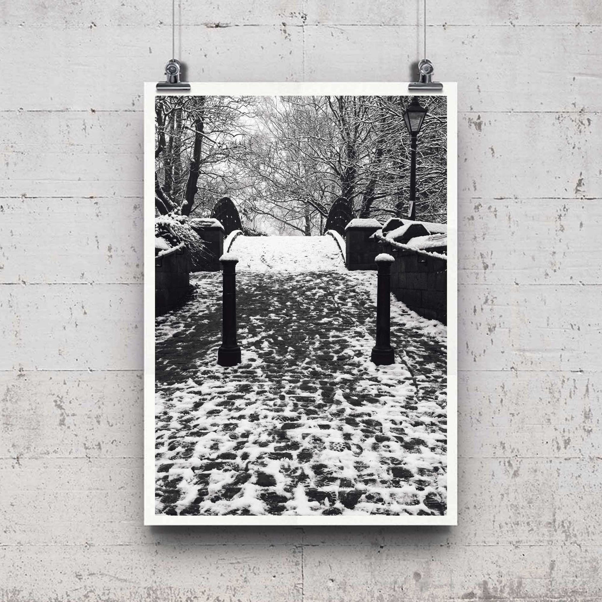 Richard Abram Photography - The photographic scenic print was taken on the Worsley canal in Greater Manchester. Taken on a wintery morning day. The image shows a snow scene with the cast-iron footbridge covered in winter snowy footprints.